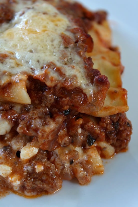 Classic Lasagna is comfort food at its finest. Cheesy, meaty, and an easy meat lasagna recipe the whole family will love. Lasagna on a white plate.