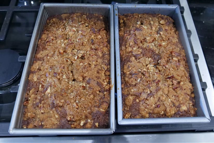 Two 8x4 loaf pans with baked apple bread in them.