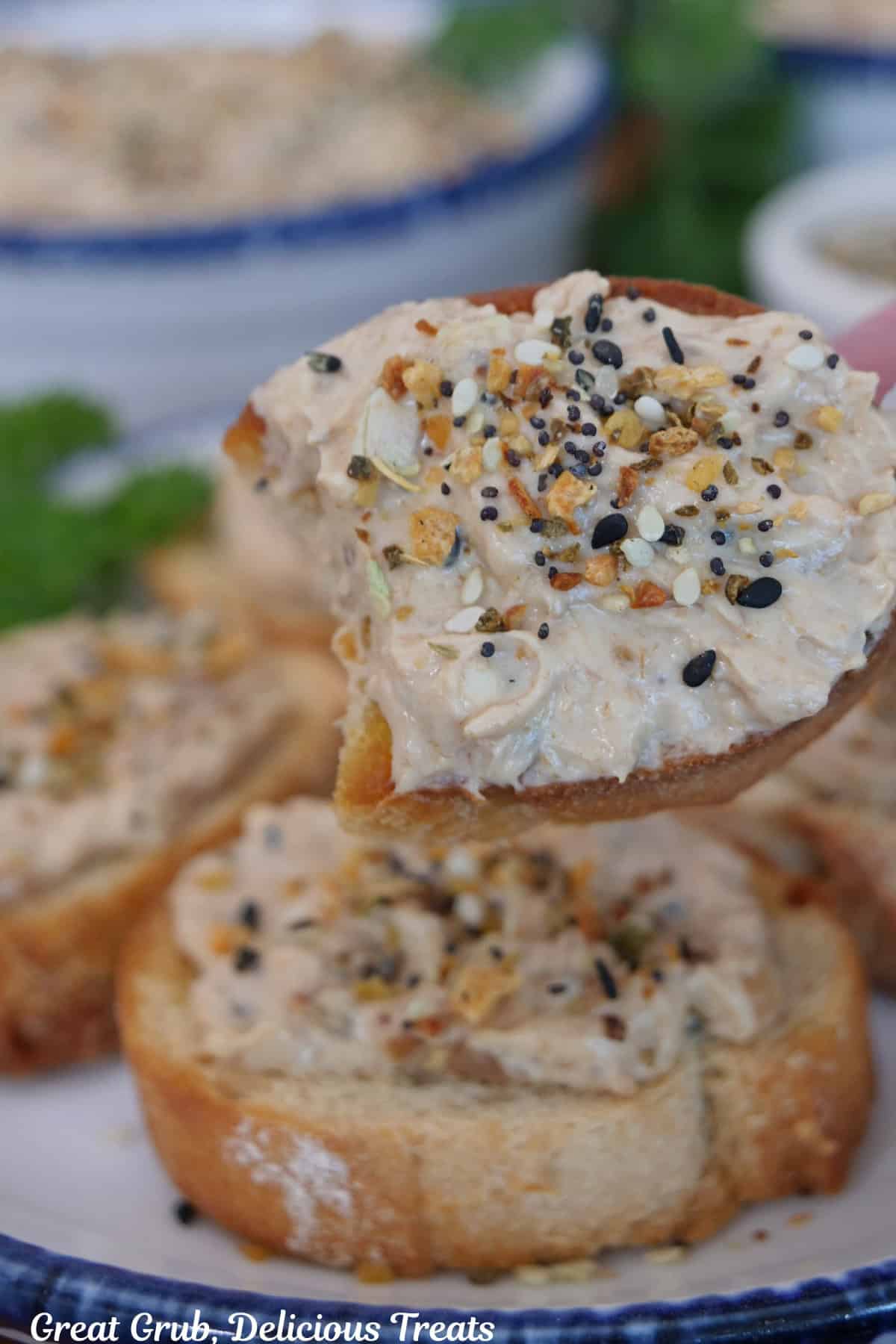 A slice of baguette bread with bacon jam dip on it with a bite taken out.