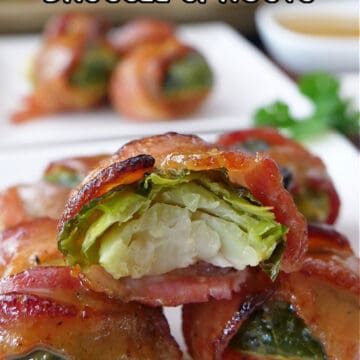 White plates with bite-size bacon wrapped brussel sprouts on them.