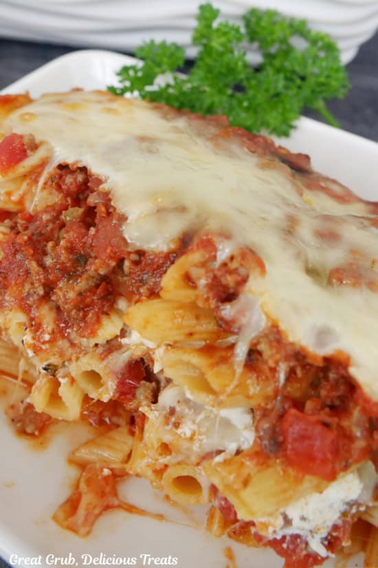 A serving of penne pasta on a white plate.