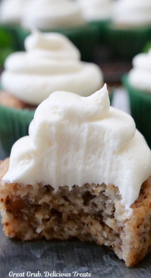 A close up of a banana nut muffin with a bite taken out of it.