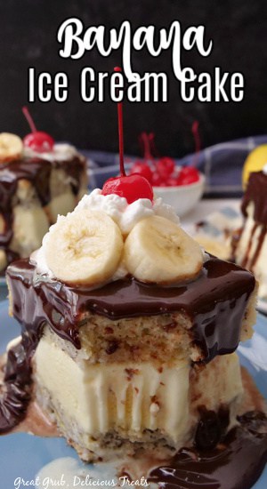 A slice of cake on a light blue plate, covered in hot fudge, with a bite taken out.
