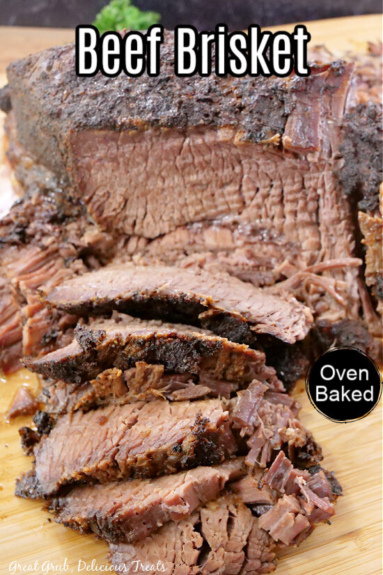 A beef brisket with a few slices cut placed on a wooden cutting board.