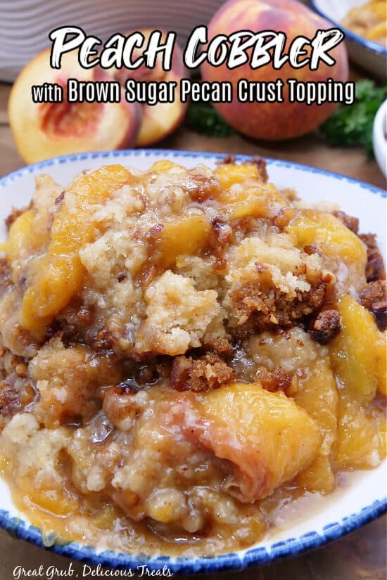 A white bowl with blue trim filled with a serving of peach cobbler.