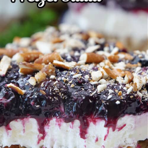 A slice of blueberry pretzel salad on a white plate.