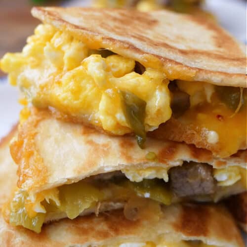 A stack of breakfast quesadillas on a white plate.