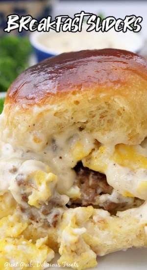 A close up photo of a breakfast slider with gravy.