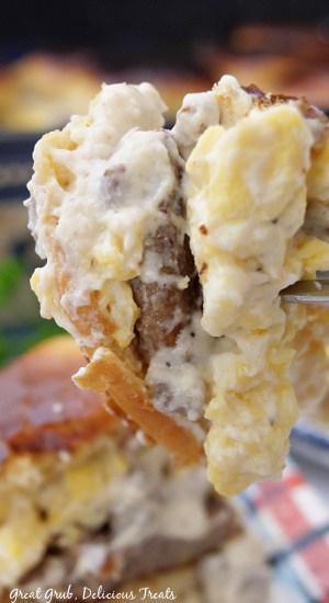 A bite of a breakfast slider on a fork.