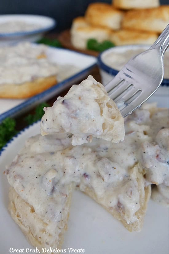 A bite of brisket gravy and biscuits on a fork.