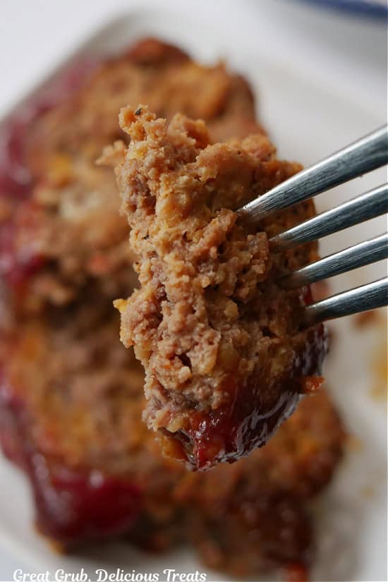 A bite of meatloaf on a fork.