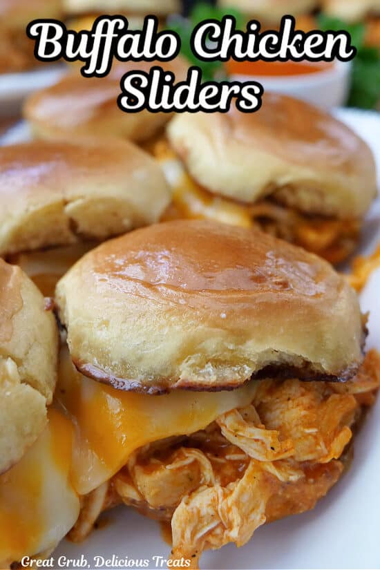 A white plate with five buffalo chicken sliders on it with the title of the recipe at the top of the photo.