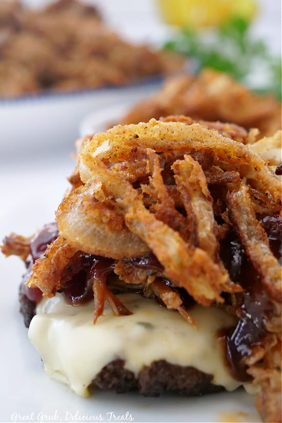 Bunless Burgers have all the flavors of a hearty burger, without the carb loaded bun. A cheeseburger topped with pulled pork, crispy onion strings, and drizzled in BBQ sauce.