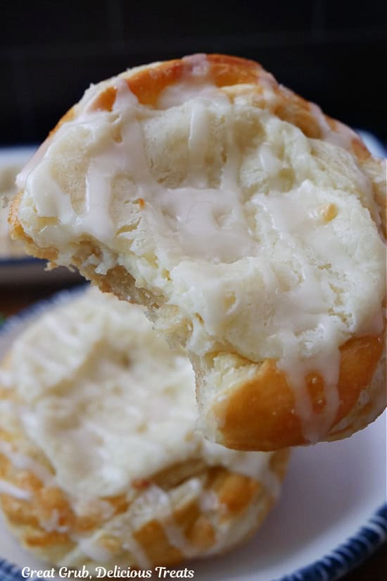 A close up of a cheese Danish with a bite taken out of it.