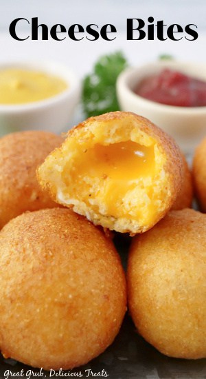 Cheese Bites are made with fresh American cheese, dipped in batter, and then fried until perfectly crispy. A cheese bite with a bite taken out of it.