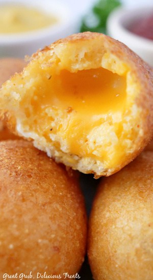 Cheese Bites are a great snack that is definitely kid approved. A close up photo of the center of a cheese bite showing gooey cheddar cheese.