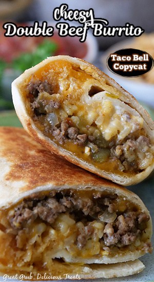 A beef burrito cut in half and one half stacked on the other.