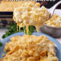 A blue plate with a serving of funeral potatoes on it.