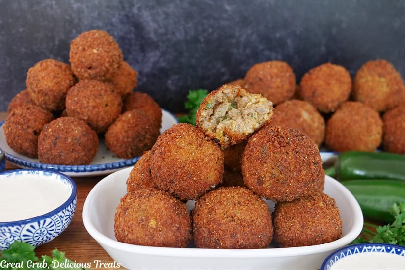 Three plates stacked with ground beef balls with a bite taken out of the one on top.