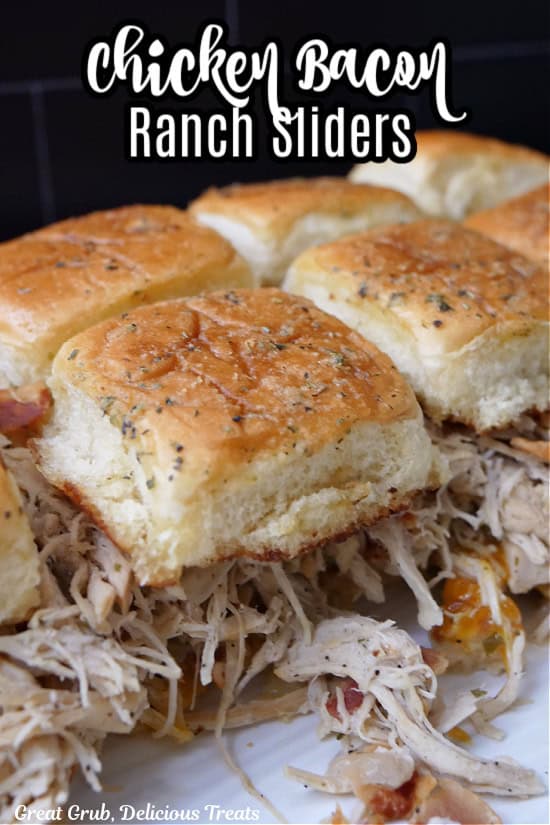 A white plate with a close up of a half a dozen chicken sliders on it with the title of the recipe at the top of the photo.