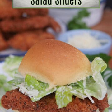A chicken caesar salad slider on a white plate with a slider bun, fried chicken, and caesar salad with the title overlay at the top.