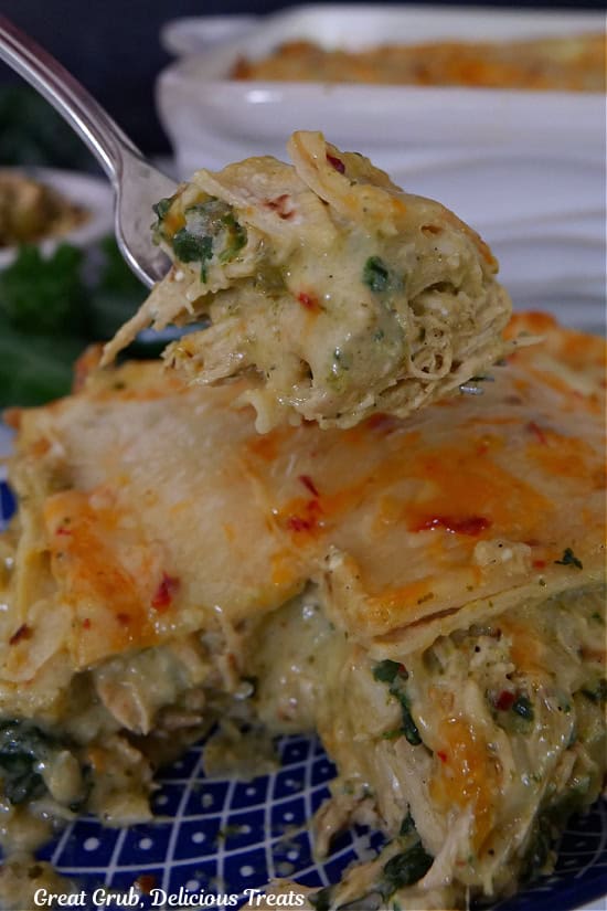 A bite of chicken poblano enchilada on a fork.
