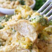 A bite of cheesy chicken swiss cheese stuffing on a fork with the title overlay at the top.