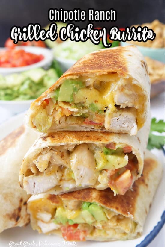 Three chicken burritos on a white plate with blue trim.