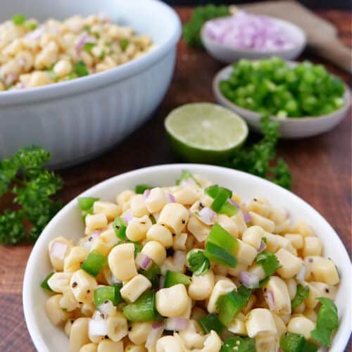 A title at the top of the picture with two bowls filled with Chipotle corn salsa.