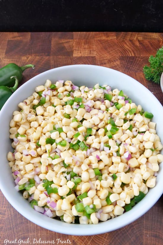 Chipotle Fresh Tomato Salsa is an easy Chipotle copycat recipe that you can easily make right at home. A very large bowl filled with corn salsa, showing corn, red onions, jalapenos, and seasoning.
