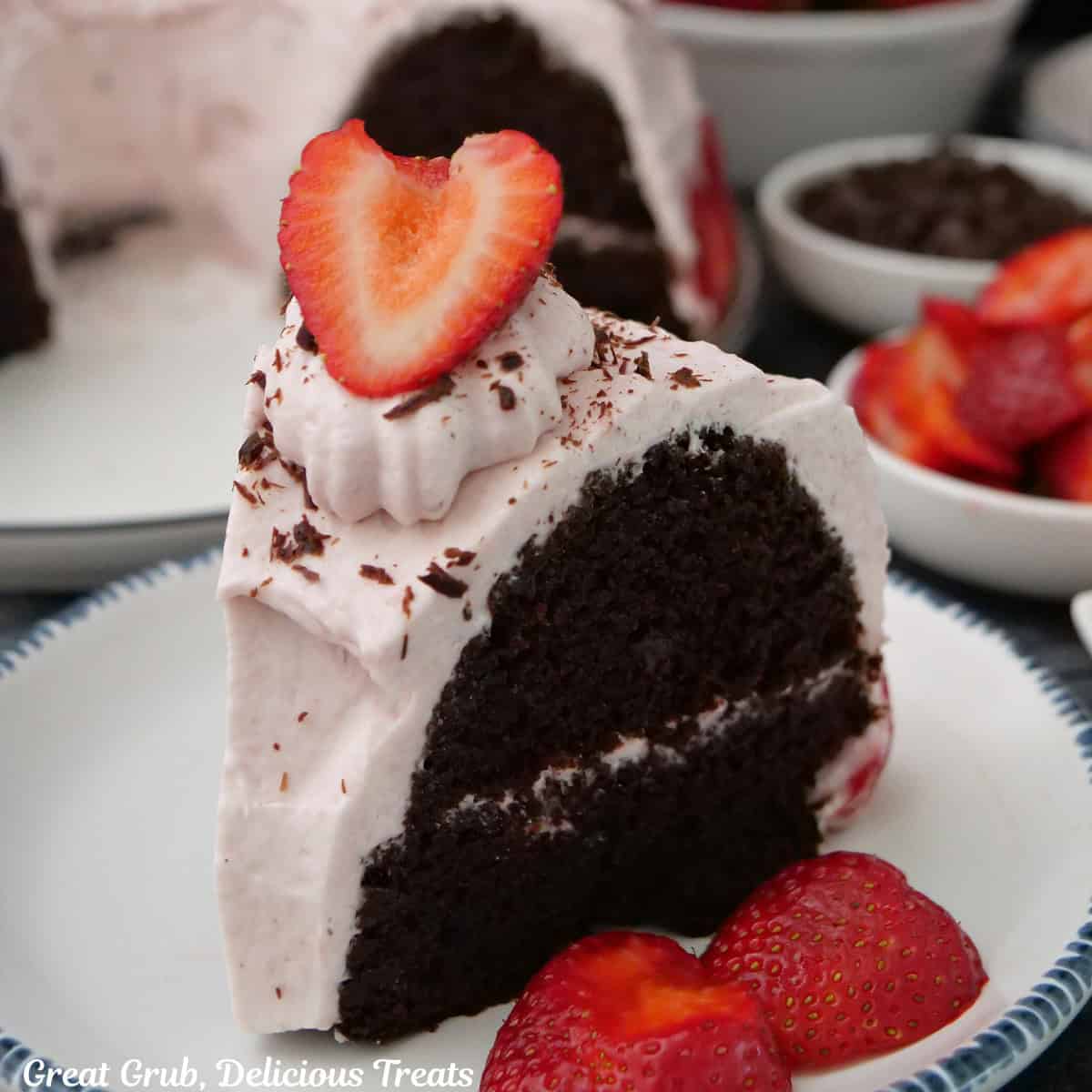 A slice of chocolate strawberry cream bundt cake on a round white plate with blue trim.