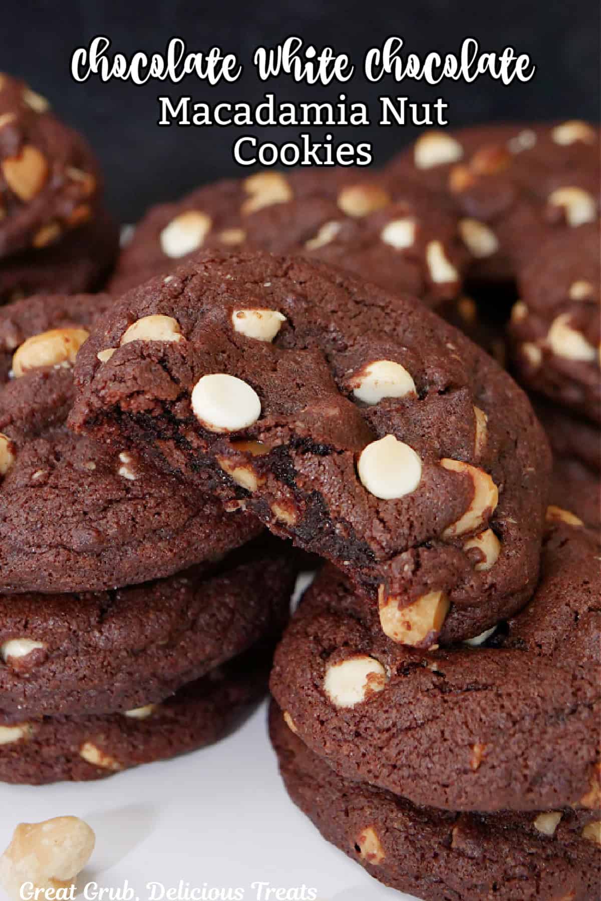 A few stacks of chocolate white chocolate macadamia nut cookies with a bite taken out of one of them.