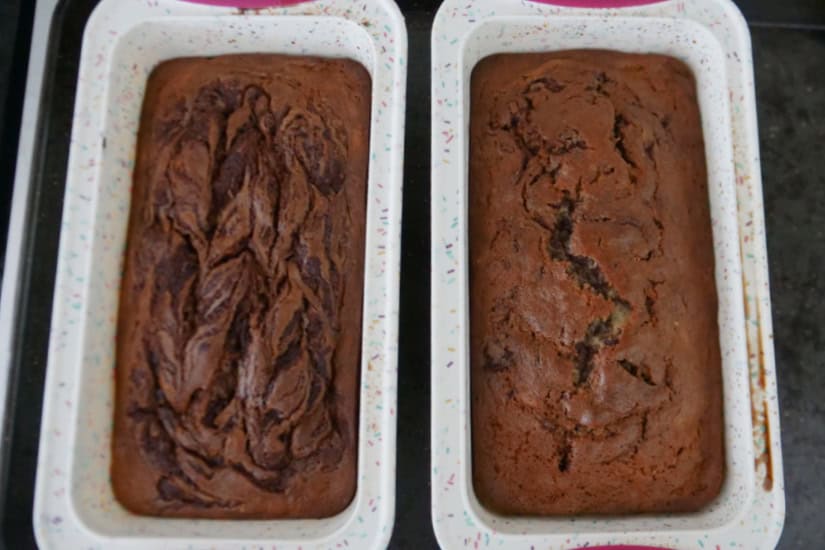 Two loaf pans filled with baked banana bread.