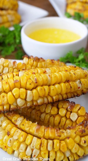 A white plate with a few corn ribs on it.
