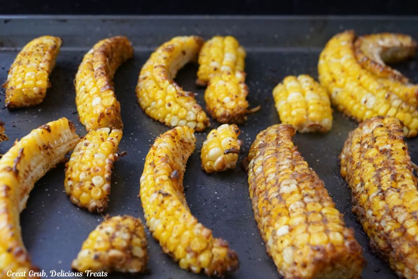 A baking sheet with corn ribs on it after baking.