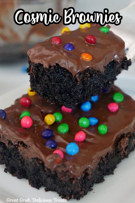 A bite of brownie held above a brownie.