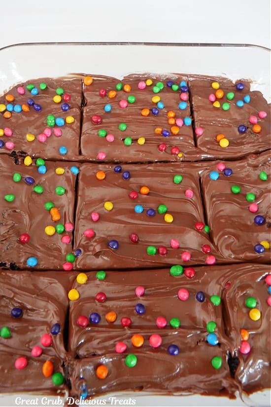 A glass baking dish with homemade brownies in it that have been cut into nine servings.