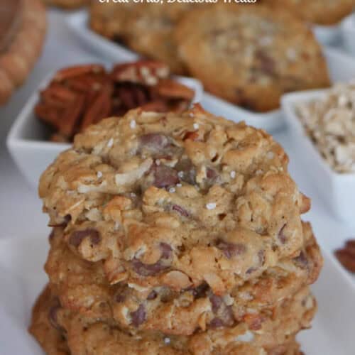 A stack of cookies on a white plate.