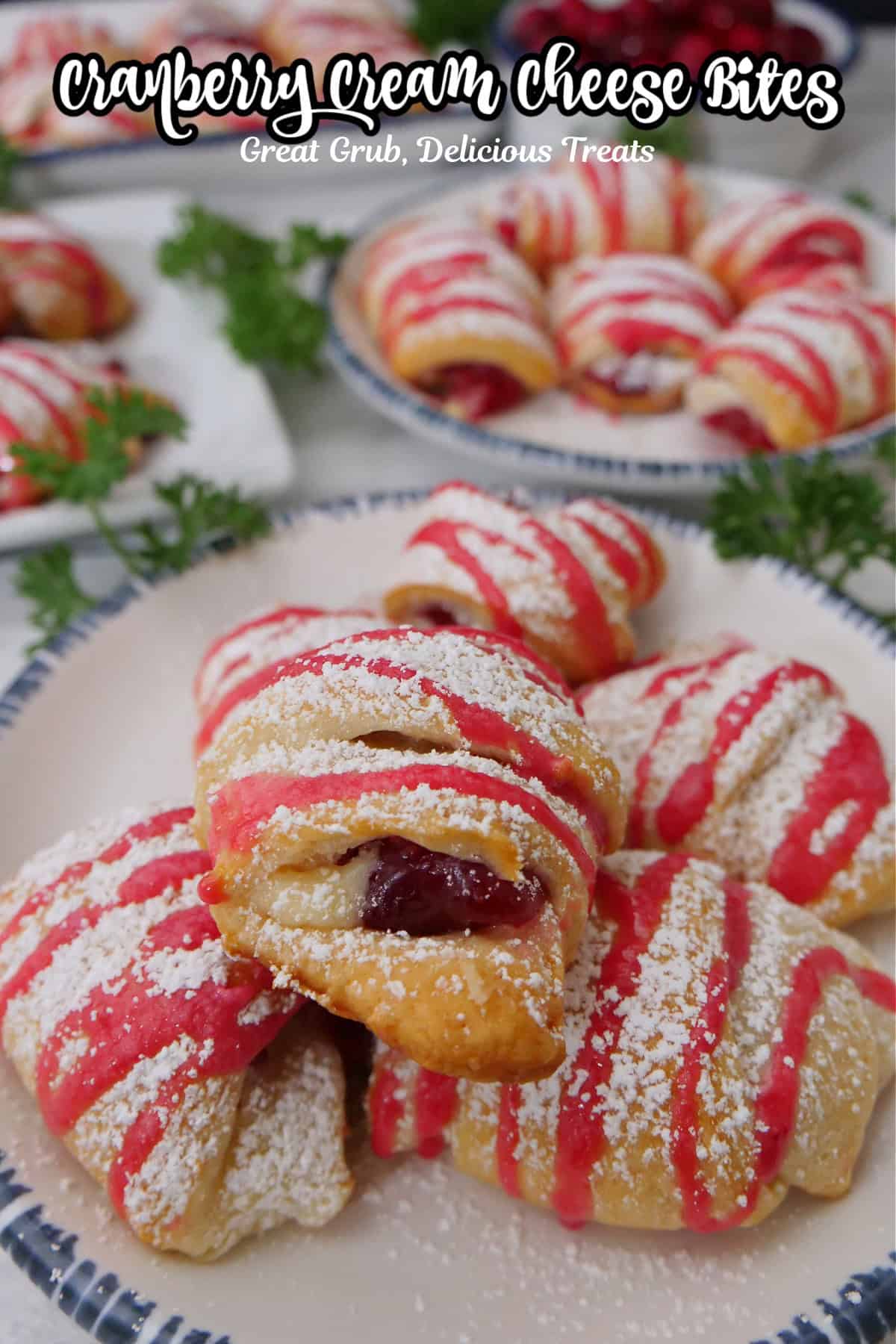 A white surface with cranberry pastry bites on a white plate with blue trim.