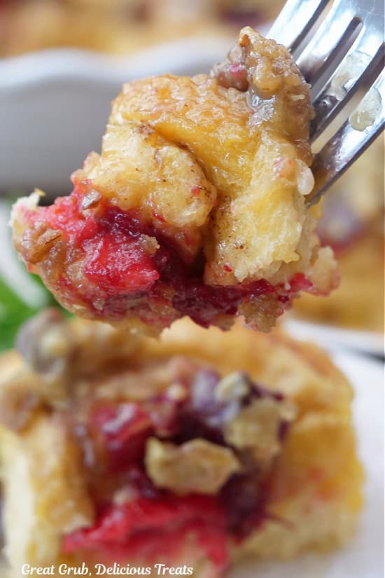 A bite of cinnamon roll on a fork.