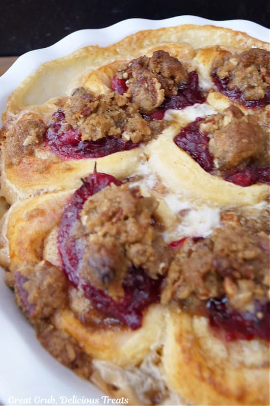A deep pie dish with cinnamon rolls in it after being baked.