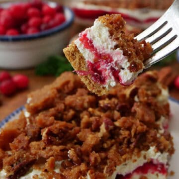 A bite of cranberry orange dessert on a fork. and the title of the recipe at the top.