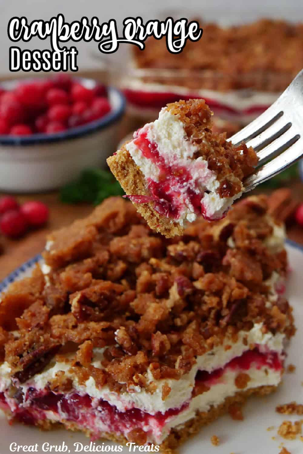 A bite of cranberry orange dessert on a fork. and the title of the recipe at the top.
