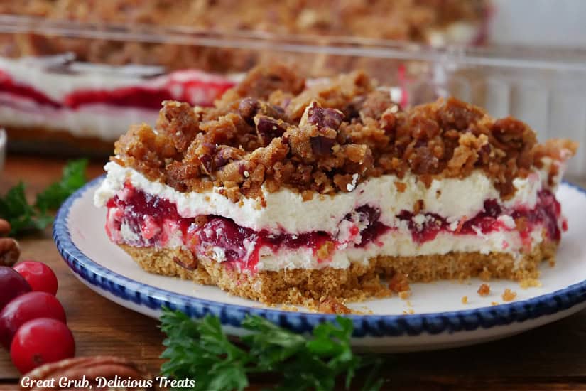 A big slice of cranberry orange dessert on a white round plate.