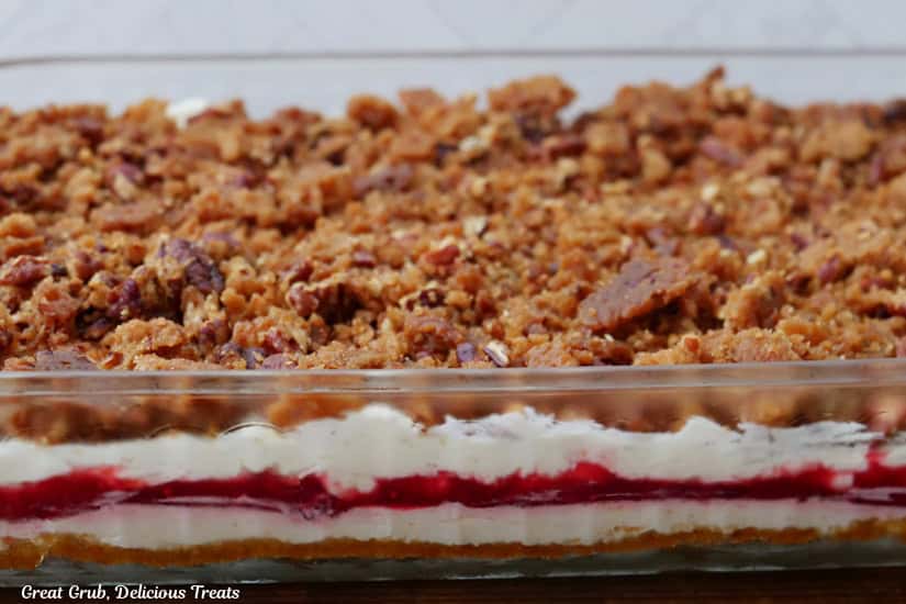 A glass 9x13 baking dish filled with a cranberry orange dessert.