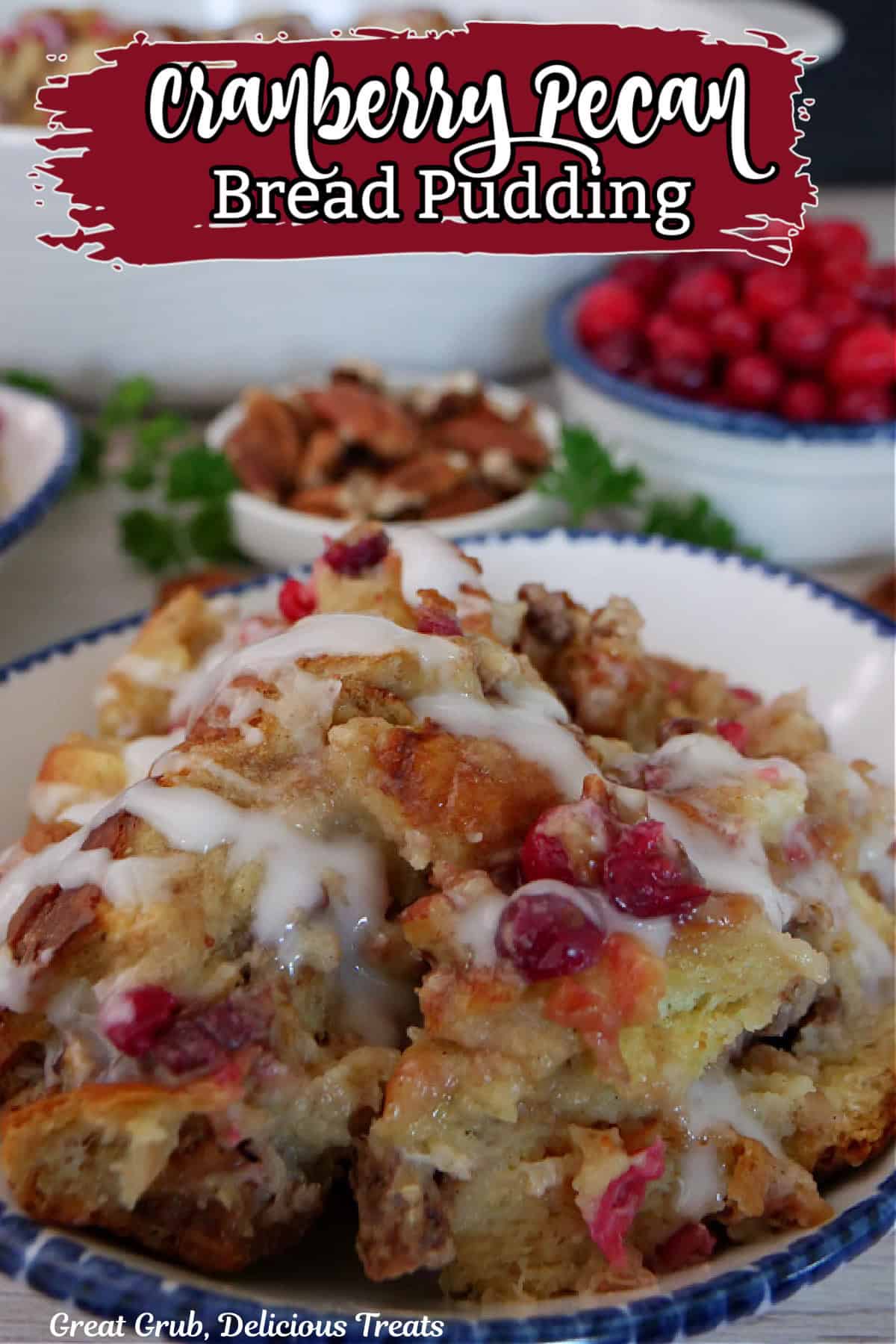 A white bowl with blue trim filled with a serving of bread pudding with cranberries and pecans.