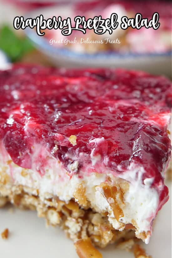 A serving of cranberry pretzel salad on a white plate.