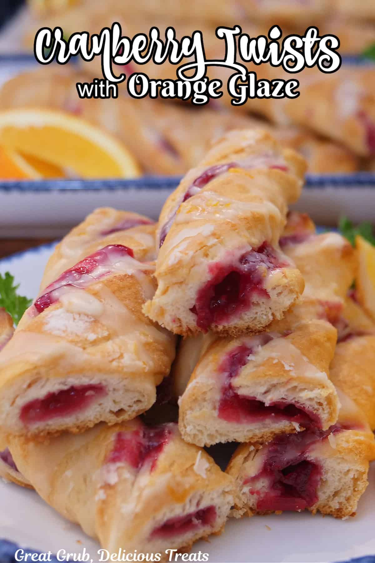 A stack of cranberry twists stacked on top of each other showing the cranberry filling inside the crescent dough, and the title overlay at the top.