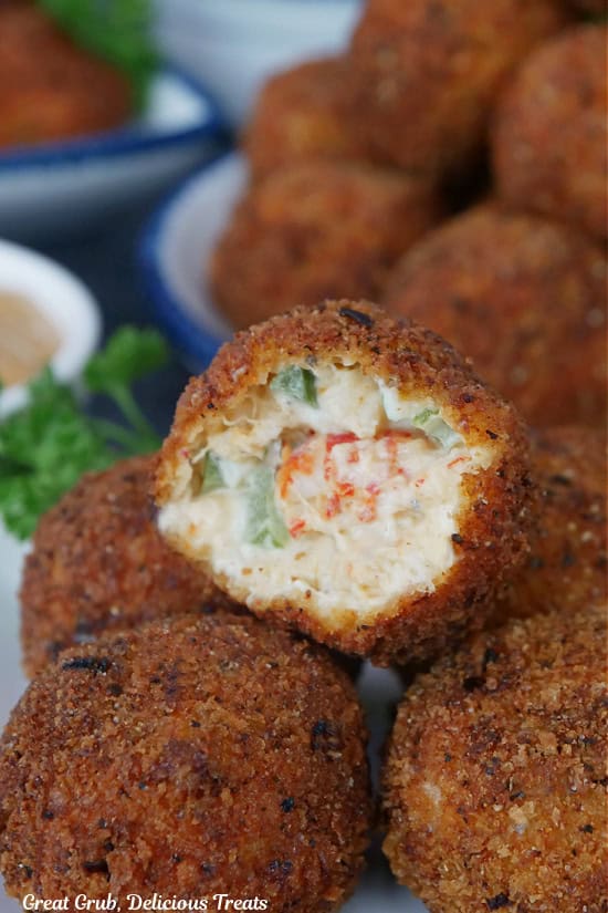 A deep-fried crawfish ball with a bite taken out of it.