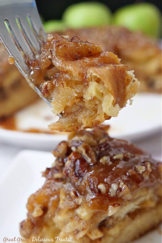 A bite of cinnamon roll on a fork.